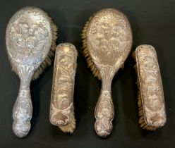 A pair of silver backed clothes Brushes and conforming hairbrushes; Birmingham 1908