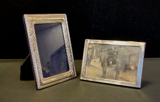 A George V silver rectangular easel photograph frame, Birmingham 1918; another silver photograph