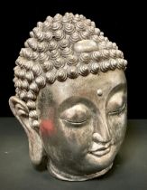 A large silver Sino-Tibetian style Buddha head, 43cm high.