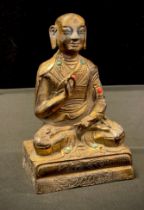 A small Sino Tibetan gilt bronzed metal figure, Buddha Meditating, 15cm high