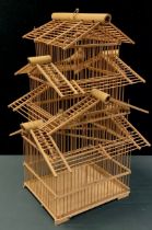 A French wooden pagoda style bird cage, three tiers with three replica birds, 65cm high, 39cm