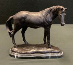 A bronzed metal model Standing Horse, black marble plinth, 22cm high