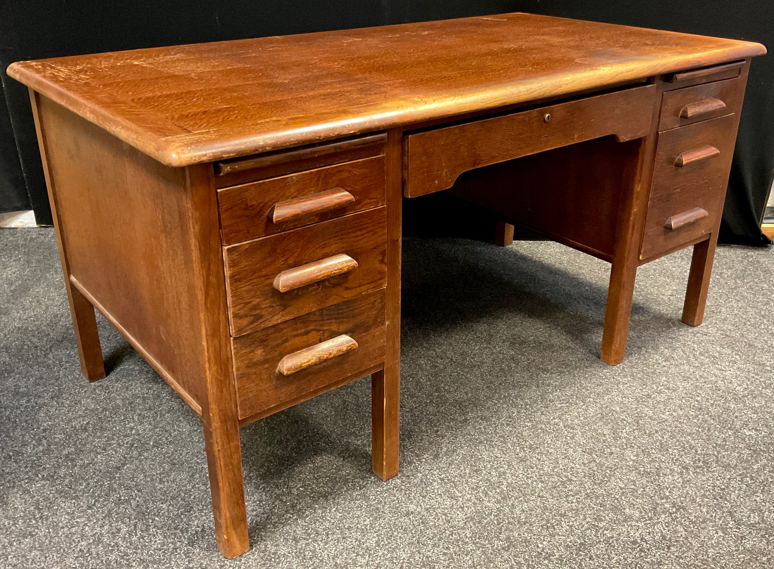 A mid century oak twin pedestal desk, by Abbess, rounded rectangular top, single long drawer to