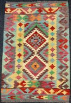 A Turkish Anatolian Kilim rug, geometric pattern in bright colours, 178cm x 117cm.