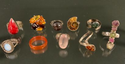 A silver mounted ammonite fossil ring, others rose quartz, coral, opal, ametrine, tourmaline, moss