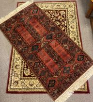 A Middle Eastern style rug / carpet, knotted in tones of red, dark blue, brown, and cream, 164cm x