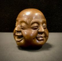 A Japanese lucky four face expression buddha paper weight, 12cm high.