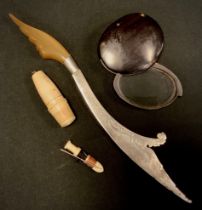 A 19th century horn travelling pocket lens; a Middle Eastern silver letter knife, horn handle; a