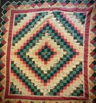 A 20th century patchwork quilt, with multi pattern square panels, floral, stripped, paisley, etc,