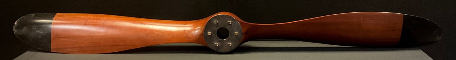 A reproduction wooden two blade propeller, black tips, metal capped hub,122cm long.