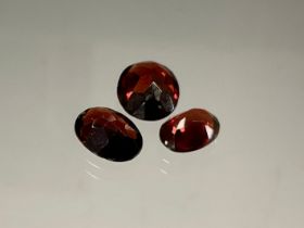 Loose Gemstones - three oval cut red garnets, total stone weight 6.84ct (3)