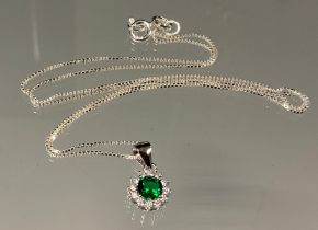 A silver mounted green and white cubic zirconia pendant necklace, 925 silver chain.