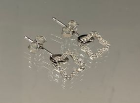 A pair of square star cubic zirconia set silver earrings.