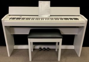A Roland Digital Piano, model F-140R, in white, with conforming piano stool.