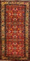 A North west Persian Malayer rug / carpet, hand-knotted with a central field of stylised flowers,