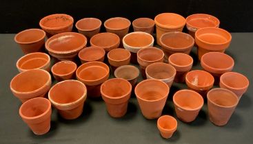 A quantity of small terracotta plant pots, sizes from 13cm high to 5cm high, (32 in total )