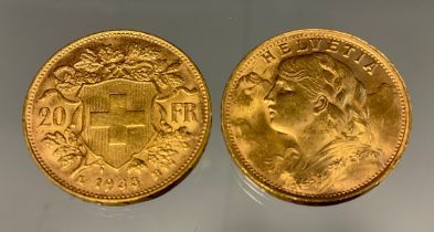 A pair of Swiss Helvetia 20 franc gold coins, both part of the Restrikes issued 1945-1947, dated