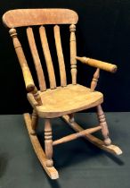 An early 20th century elm children's rocking chair, 70cm x 42cm x 47cm