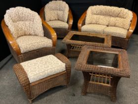 A cane wicker-work conservatory suite - comprised of a two-seat sofa, pair of armchairs,