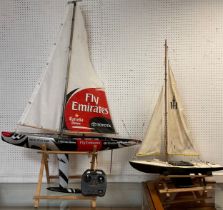 A Fly Emirates racing pond yacht, composite hull, single mast, in black, grey and red, fitted with