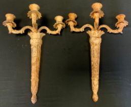 A pair of ornate cast iron candelabras, painted white,45cm long
