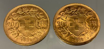 A pair of Swiss Helvetia 20 franc gold coins, both part of the Restrikes issued 1945-1947, dated