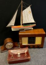A model pond yacht, single mast and sail, wooden hull painted red and white, 55cm high, 62cm long;