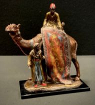 An Austrian rug seller and camel table strike lighter, manner of Franz Bergman, with patinated and