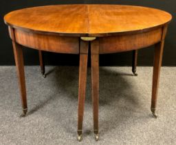 A George III mahogany dining table (extending dining table, but lacking its additional leaves),