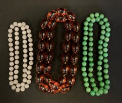 A single strand green bead necklace, possibly jade, 76cm long; another white stone, 64cm long; other