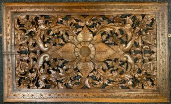A carved wooden rectangular plaque, pierced floral centre within scrolling surround, dotted boarder,