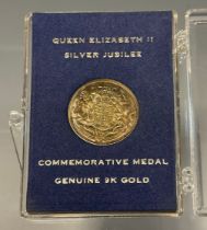 A Queen Elizabeth II silver jubilee 9ct gold token, 2.6g, cased