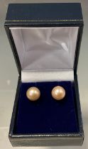 A pair of pale pink cultured pearl stud earrings, 9ct gold fittings, 2.5g gross, boxed