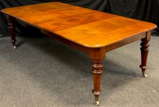 A Victorian mahogany extending dining table, the rounded rectangular top, with two additional