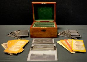 A stereoscopic Treasury dome topped box with assorted glass and card stereoscopic cards, topics