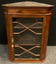 A 19th century mahogany wall-mounted corner cabinet, dentil cornice, astral glazed door, enclosing