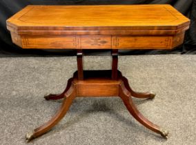 A 19th century mahogany games table, canted rectangular fold-over top, with red baize interior,