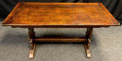 A mid 20th century oak trestle dining table, 76cm high x 152.5cm long x 74.5cm wide.