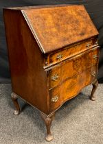 A 19th century style burr walnut veneered bureau, hinged fall door to top, enclosing a fitted