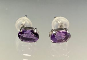 A pair of oval amethyst stud earrings, total estimated amethyst weight approx 0.80ct, 18ct white