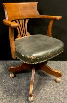 An early 20th century oak swivel desk chair, 61.5cm wide.