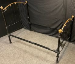 A Victorian cast iron and brass small double bed frame, 150cm high x 200cm wide x 120cm deep.