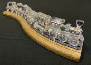 Swarovski crystal - a train set comprising locomotive and five carriages, wooden train track stand
