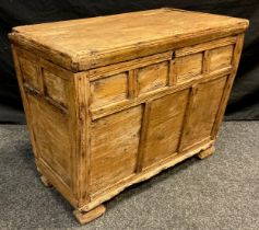 A 19th century Continental distressed pine box, probably French, hinged lid, multi panelled slightly