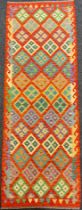 A Turkish Anatolian Kilim rug / carpet, knotted in bright colours with a field of repeating diamonds