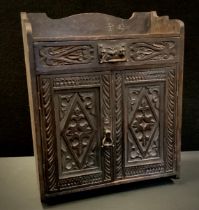 An Arts and Crafts style chip carved smokers cabinet, 45cm x39 cm