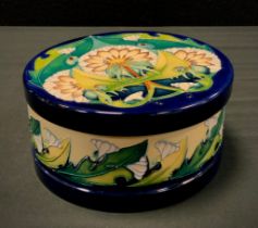 A Moorcroft pottery circular lidded box, decorated in the Art Nouveau style Seeds pattern with