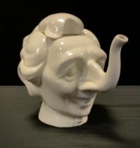 A Luck & Flaw white glazed teapot and cover in the form of Margaret Thatcher, impressed factory mark