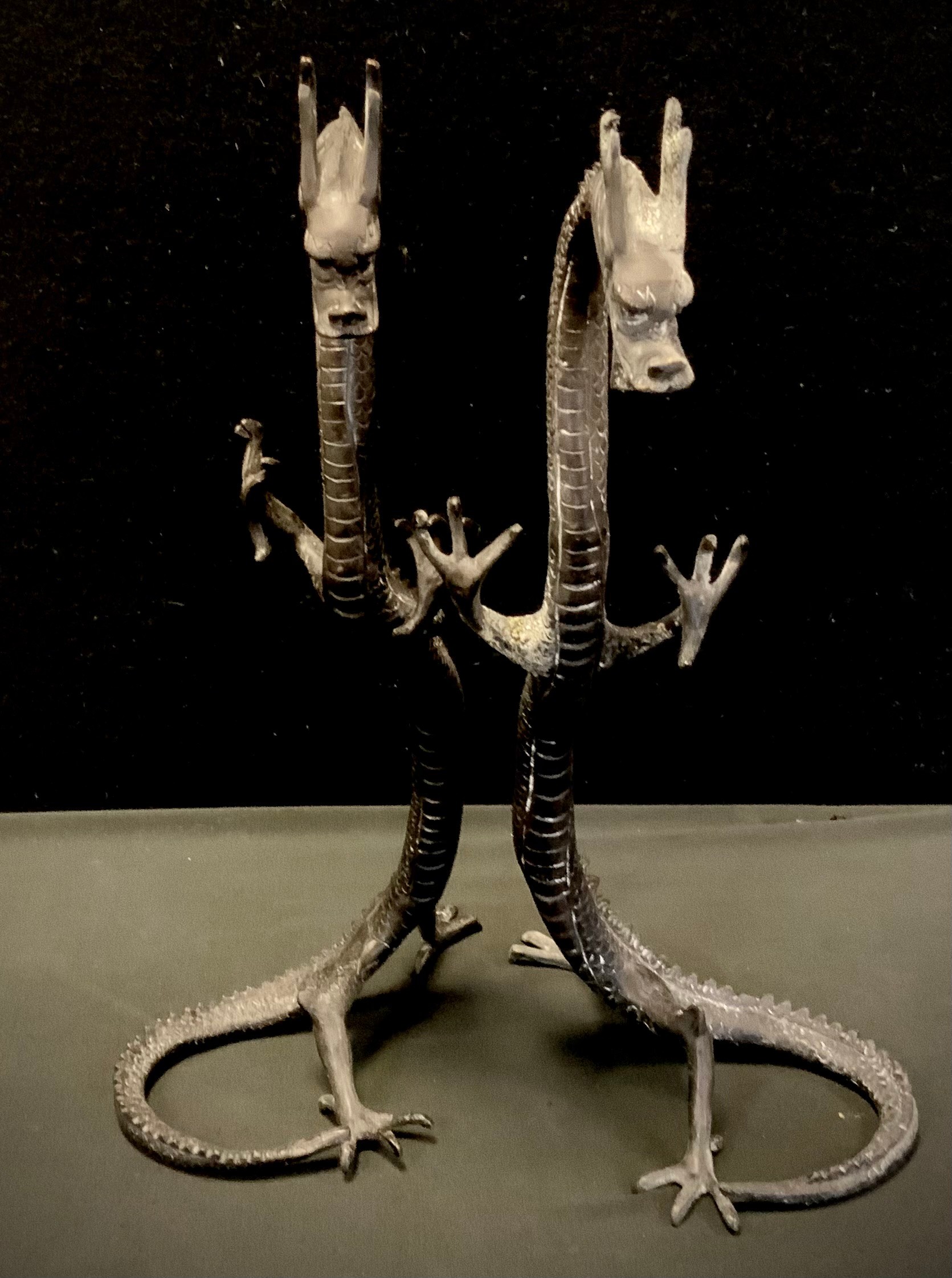 A pair of bronzed metal dragons, rearing, 41cm high