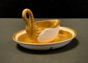 A Dresden oval cup and saucer, the cup formed as a swan with a curling neck forming the handle,